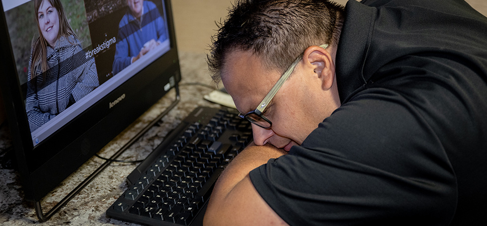 Man lying down at computer