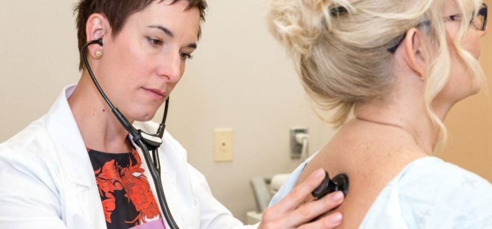 Dr Penz listening to patient's lungs