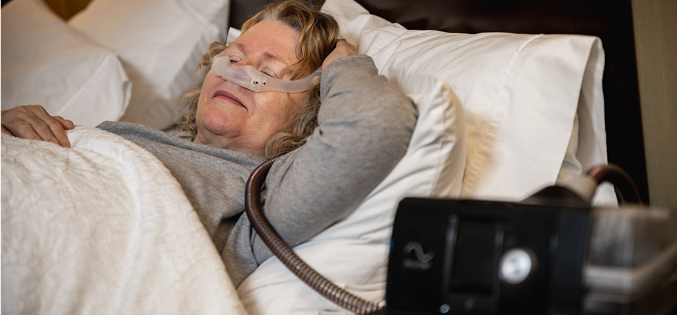 Lady sleeping with cpap mask on